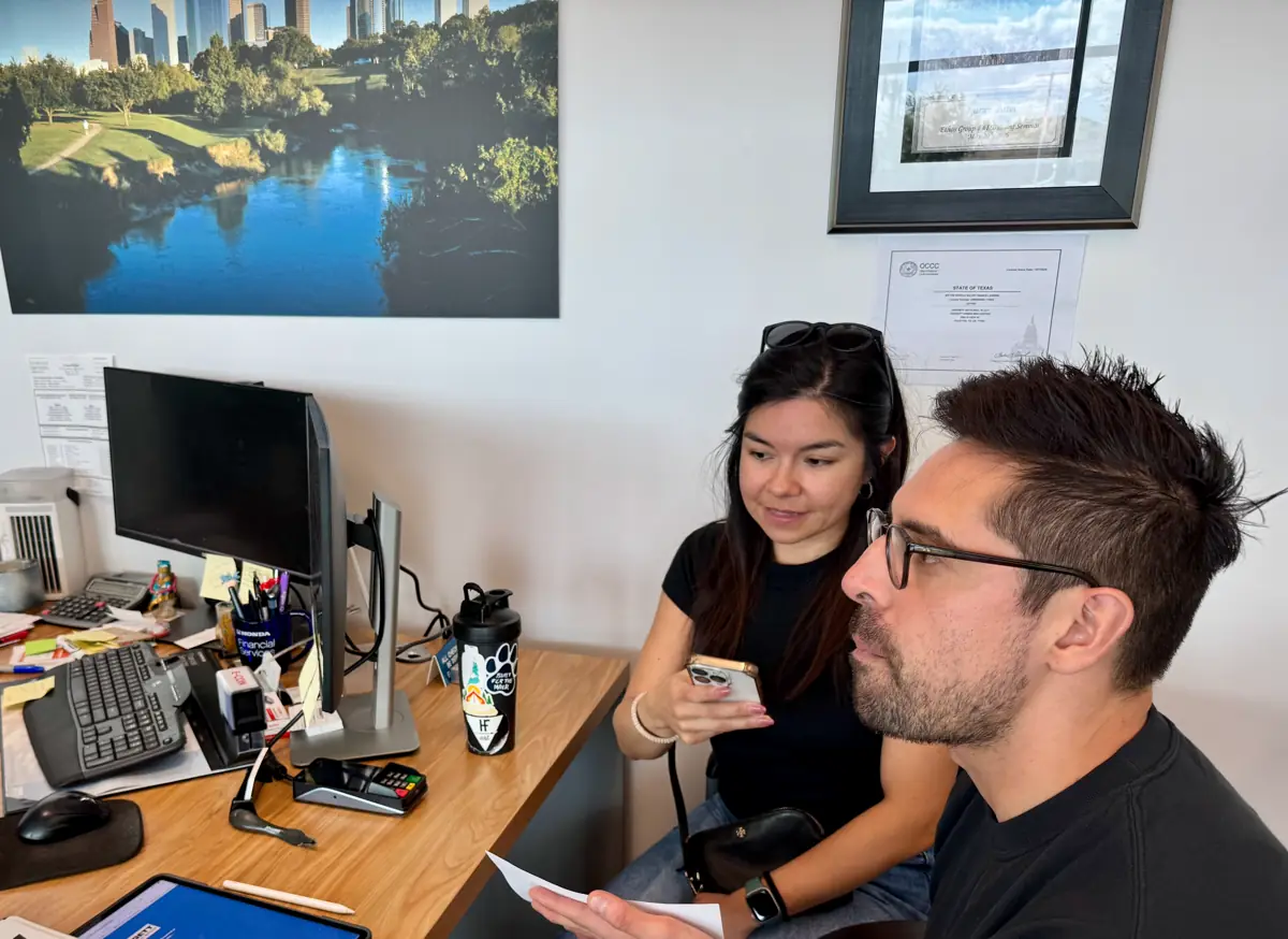 Samantha Quinones going over a business owner's reviews on a phone at their desk