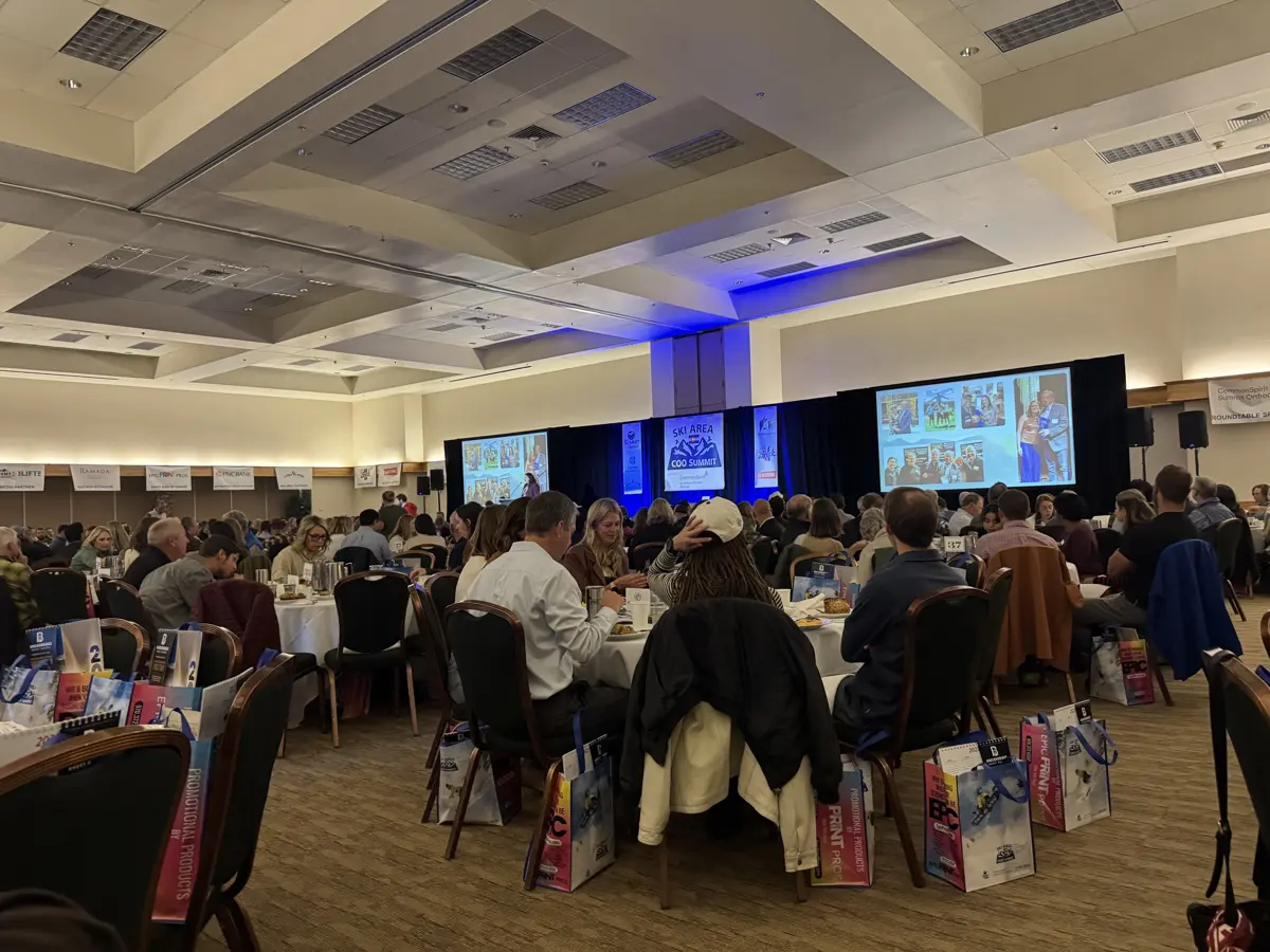 A full ballroom of Summit County business leaders at round tables facing the stage at the Ski Area COO Summit