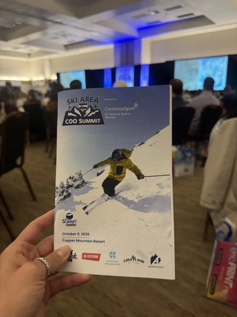 Samantha holding the Ski Area COO Summit program, October 9, 2026, Copper Mountain Resort, in the event ballroom